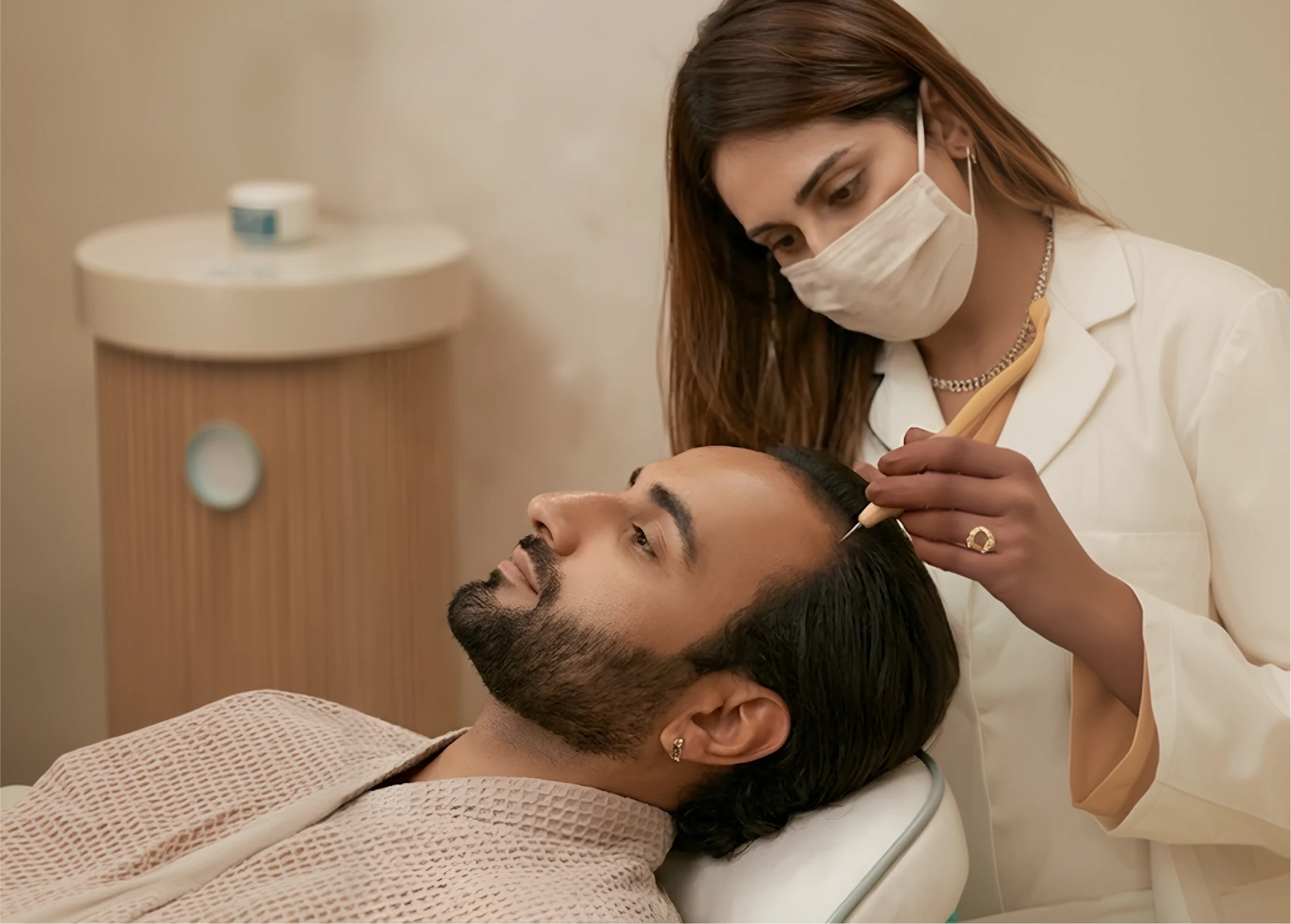 Dermatologist examining a patient's scalp using a dermatoscope under sterile conditions